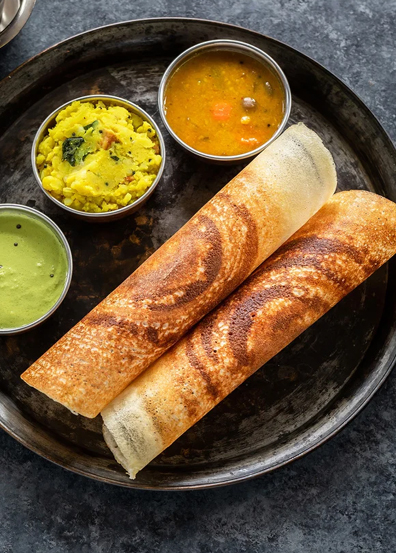 Idli dosa vada served with sambar and chutneys in South Indian catering